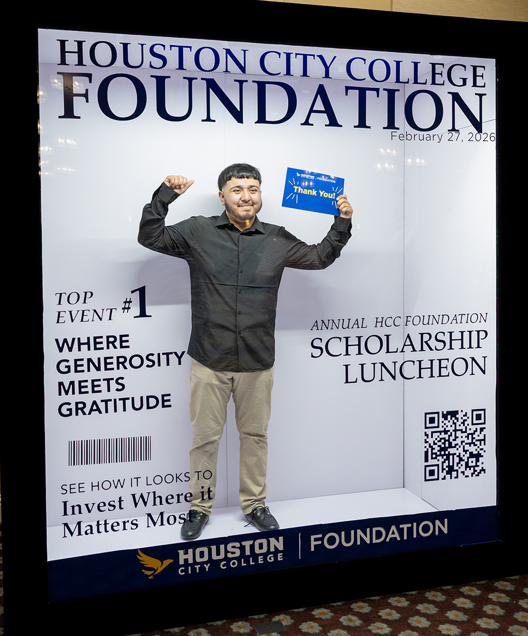Scholarship Luncheon attendee posing with a &ldquo;Thank You&rdquo; card inside a magazine-style photo booth display at the Houston City College Foundation event.