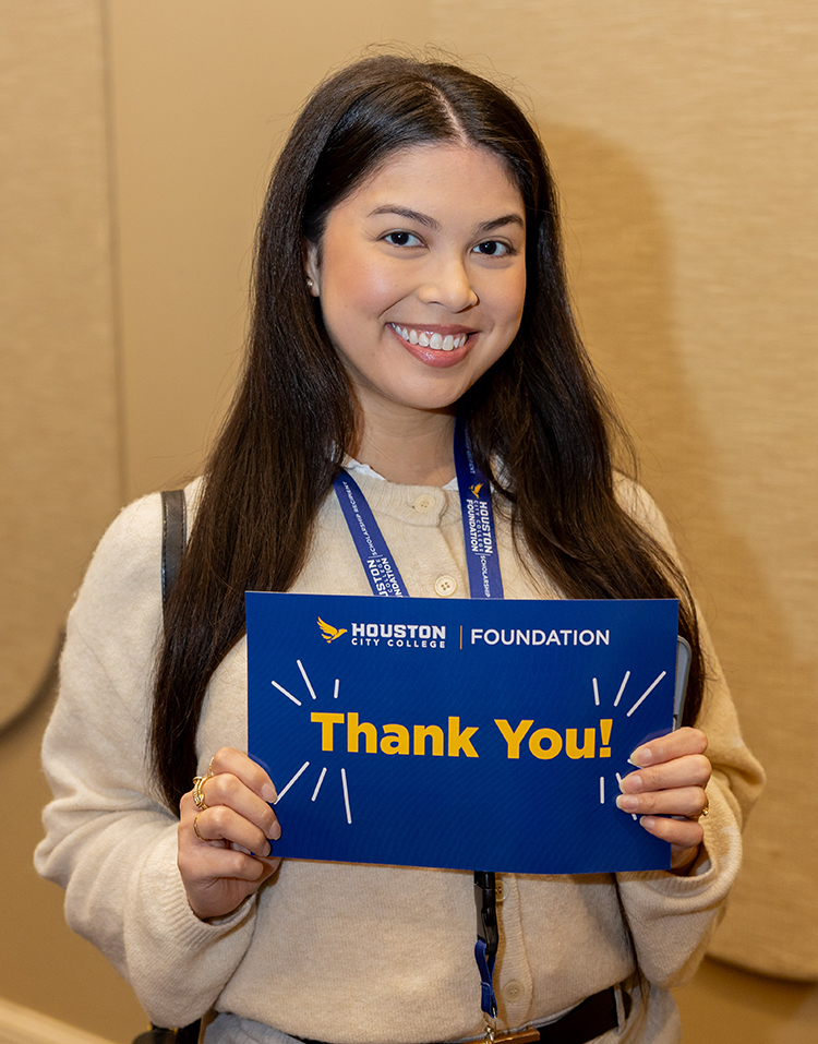 Scholarship recipient holding a &ldquo;Thank You&rdquo; card at the Houston City College Foundation Scholarship Luncheon.