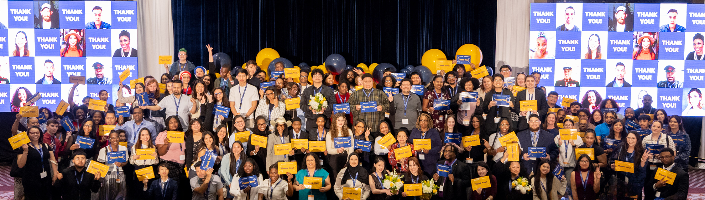 Group photo of scholarship recipients and attendees holding &ldquo;Thank You&rdquo; cards at the Houston City College Foundation Scholarship Luncheon.